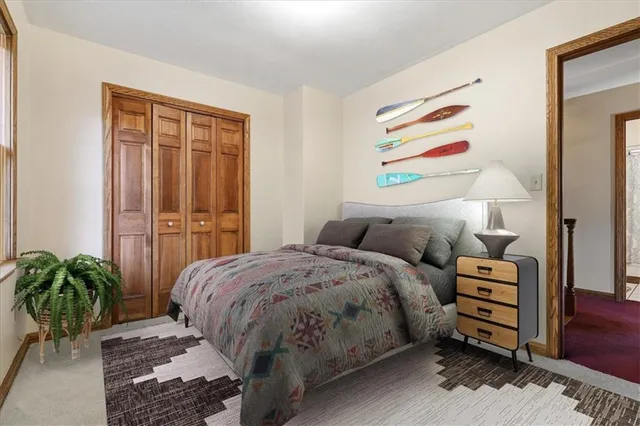 a bed sitting in a bedroom next to a window