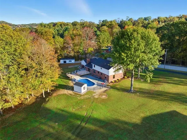 a swimming pool with some trees in the background