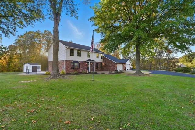 a view of a house with a back yard