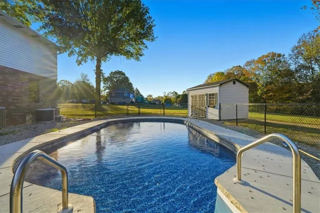 a view of swimming pool with a back yard