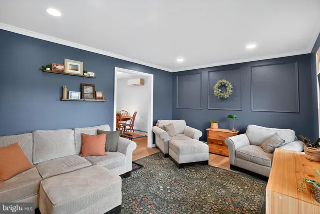 a living room with furniture and painting on the wall