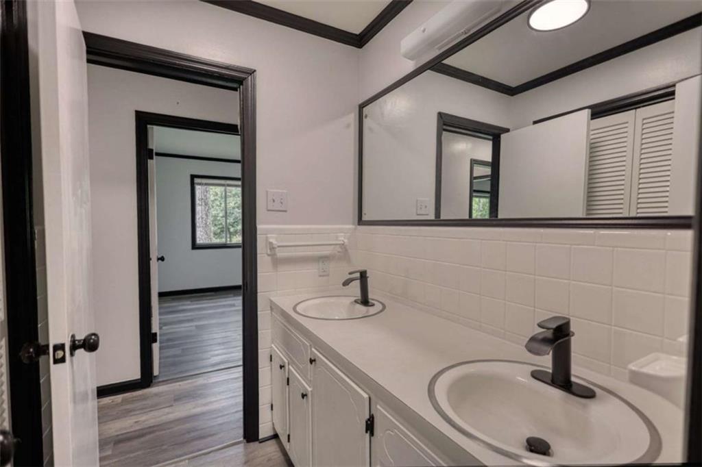 555 Joy Street Jackson, GA 30233 - Photo 33 of 56 a bathroom with a sink and a mirror
