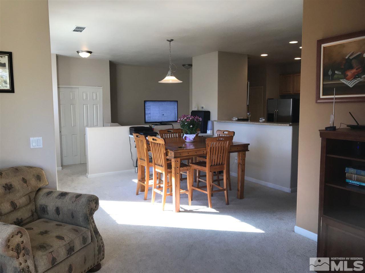 900 South, Unit 2424 Reno, NV 89521 - Photo 3 of 9 a living room with furniture and a dining table with kitchen view