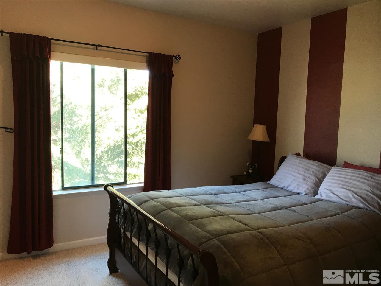 900 South, Unit 2424 Reno, NV 89521 - Photo 7 of 9 a bedroom with a bed and a window