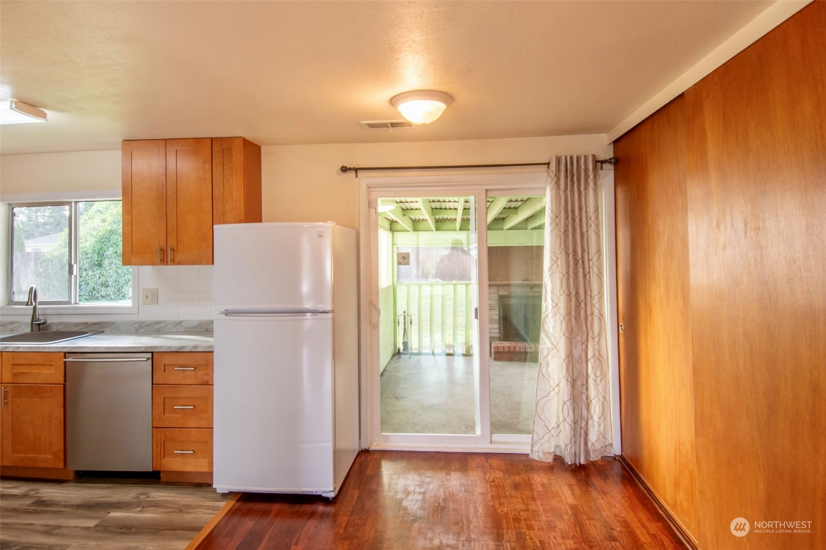 17039 123rd Avenue Southeast Renton, WA 98058 - Photo 3 of 11 a kitchen with a refrigerator and wooden floor