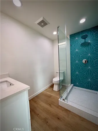 a large kitchen with granite countertop a large counter top stainless steel appliances and cabinets
