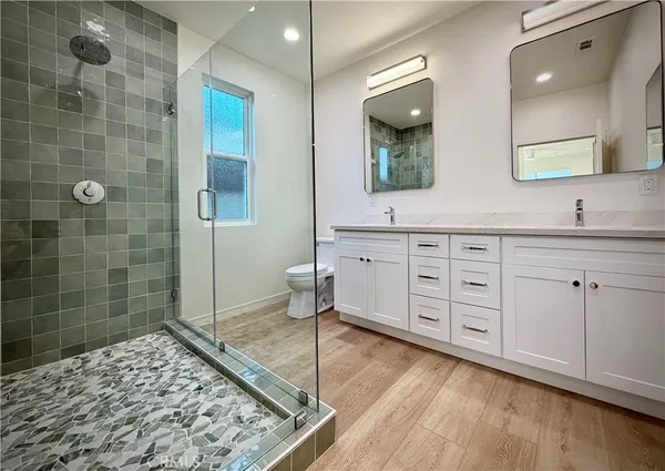 a bathroom with a bathtub shower sink vanity and toilet