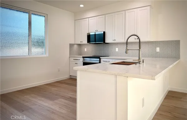 a spacious bathroom with a double vanity sink a mirror and a bathtub