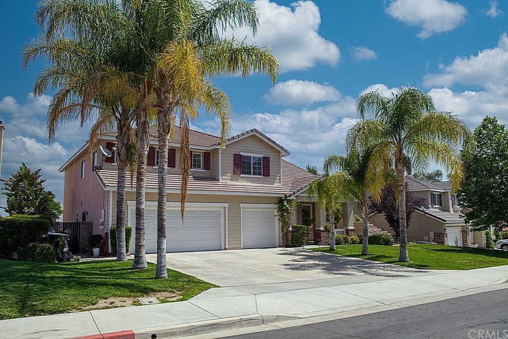 176 Alabaster Loop Perris, CA 92570 - Photo 1 of 1 front view of house with a yard and palm trees