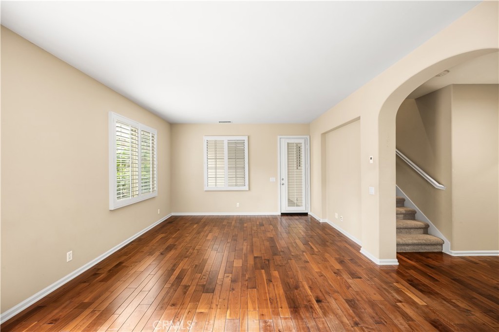 56 Pathway Irvine, CA 92618 - Photo 13 of 52 an empty room with wooden floor and windows