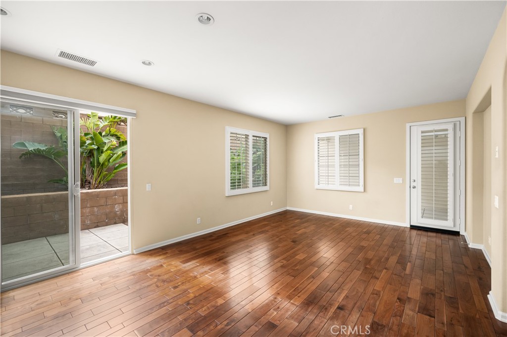 56 Pathway Irvine, CA 92618 - Photo 14 of 52 a view of empty room with wooden floor and fan
