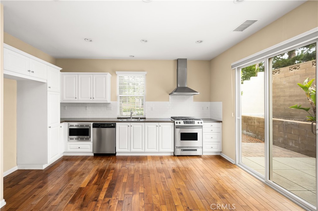 56 Pathway Irvine, CA 92618 - Photo 9 of 52 a kitchen with granite countertop a stove top oven and cabinets
