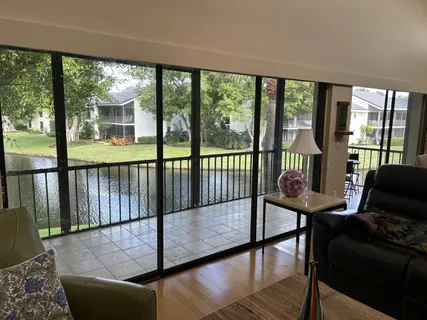 a living room with furniture and a floor to ceiling window