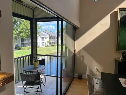 a view of a chairs and table in the balcony