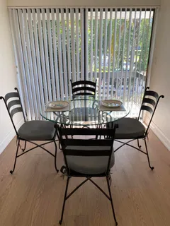 a view of a chairs and table in the balcony