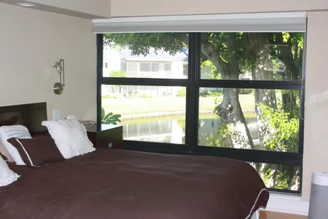 a bed sitting in a bedroom next to a window