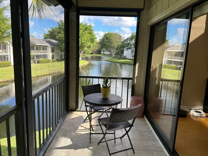a view of a room with balcony and furniture