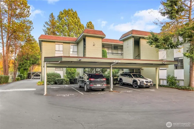 a car parked in front of a white house
