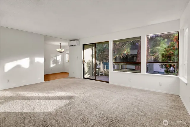 a view of a big room with windows and chandelier