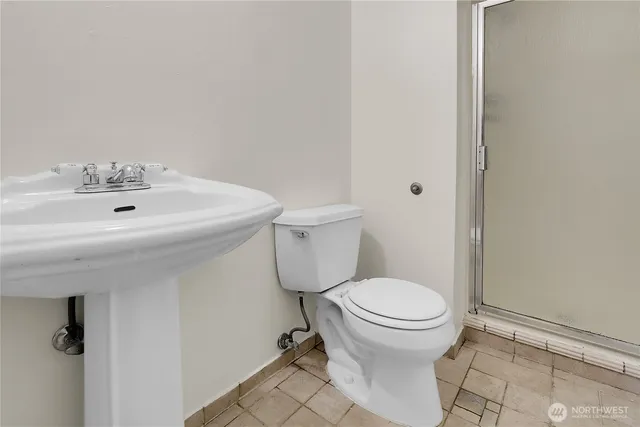 a bathroom with a sink toilet and a mirror