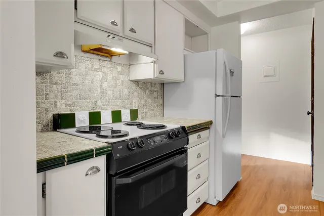 a kitchen with stainless steel appliances granite countertop a stove and a refrigerator