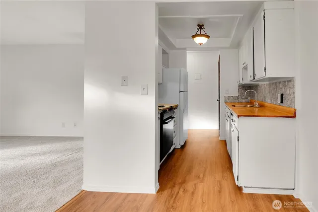 a kitchen with stainless steel appliances a refrigerator and a stove