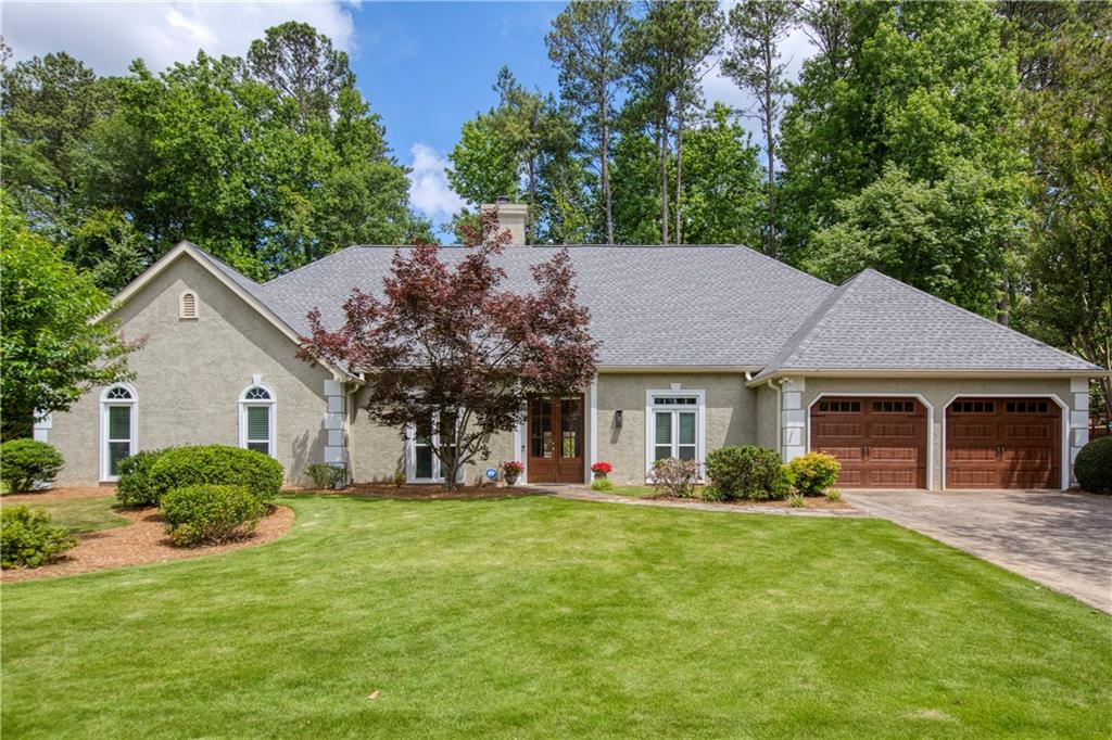 a front view of house with yard and green space