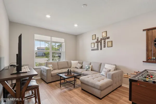 a bedroom with a bed and a flat tv screen on the dresser