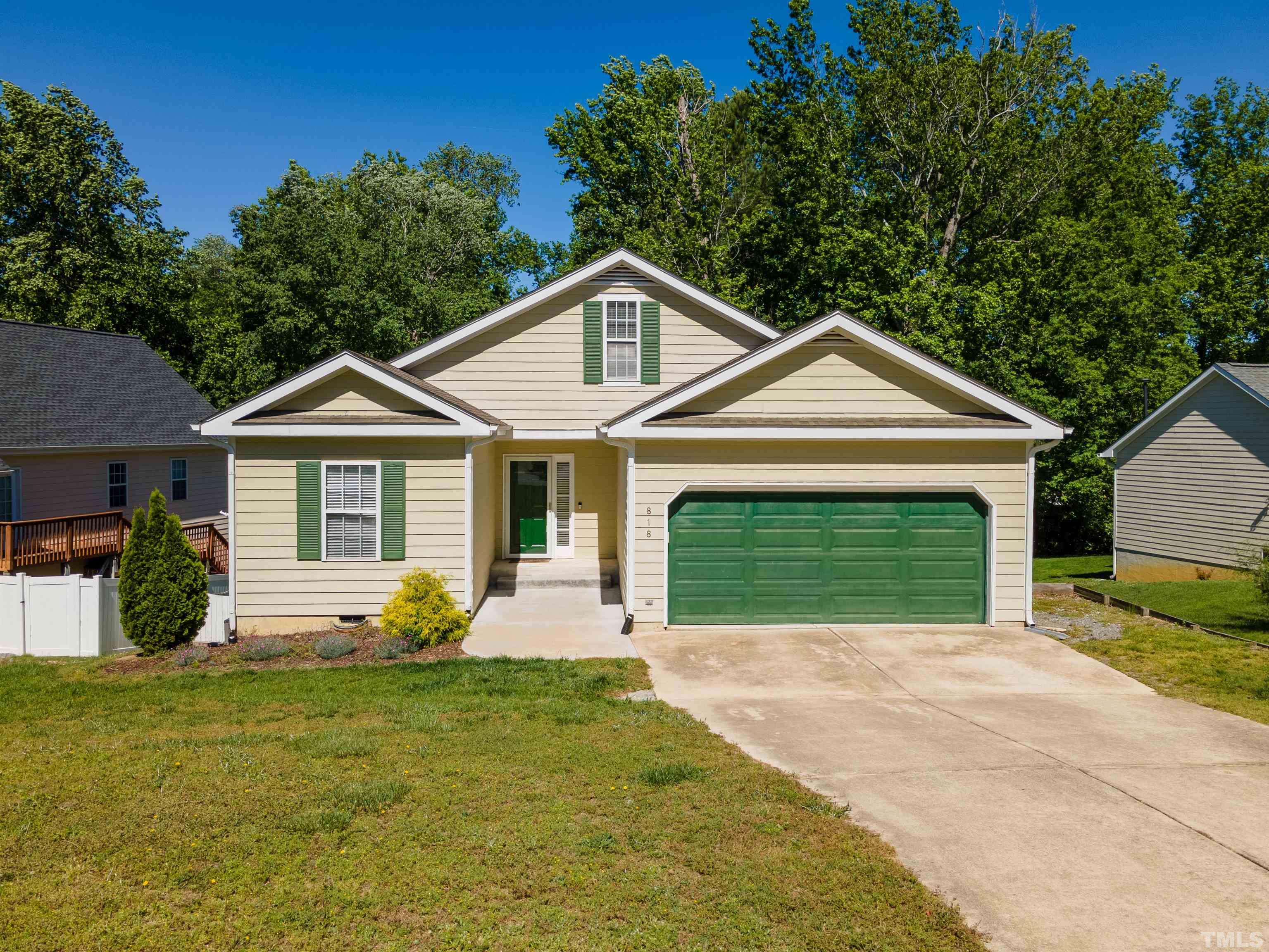 a front view of a house with yard and garage