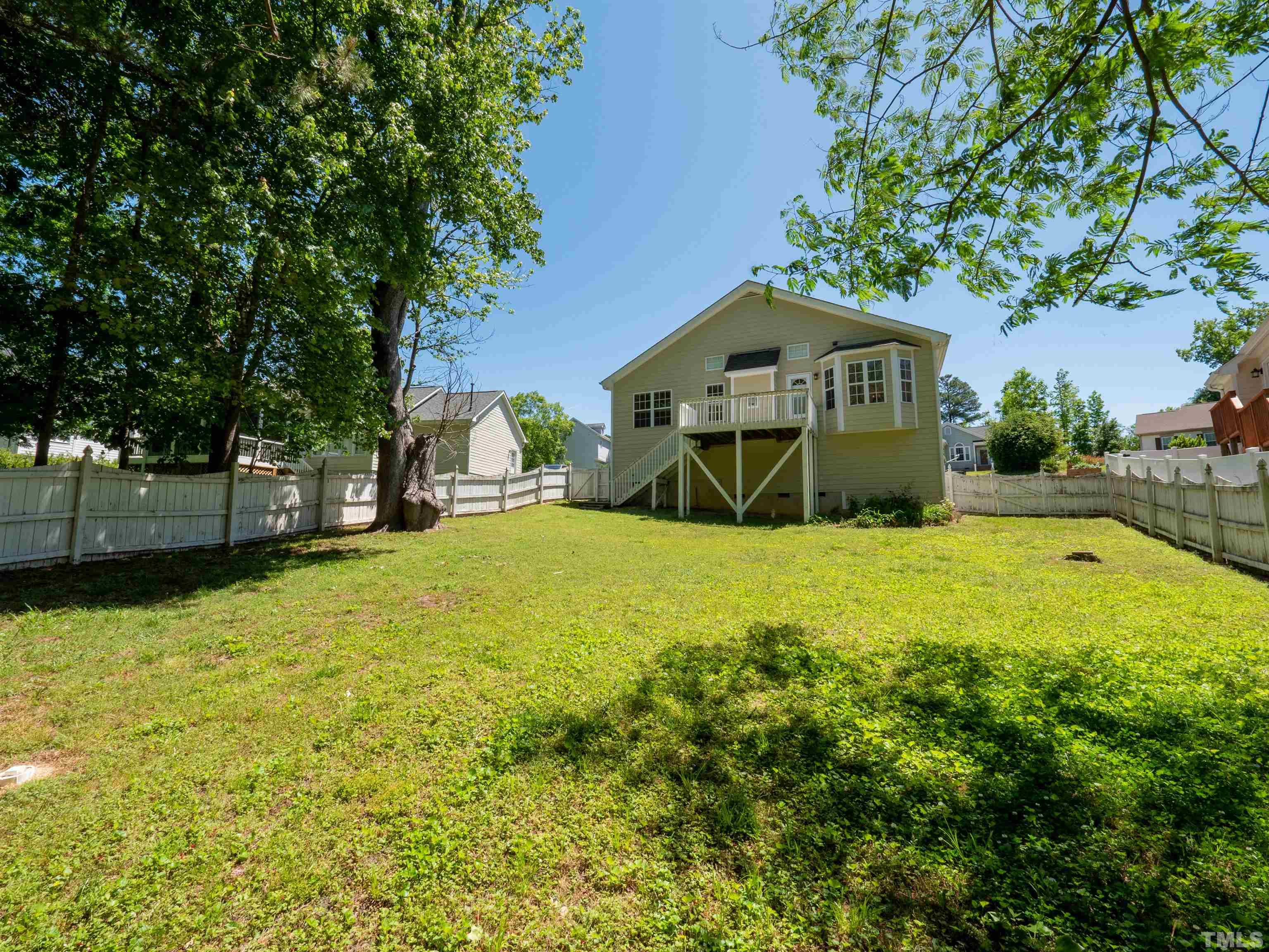 818 Shackleton Road Apex, NC 27502 - Photo 14 of 20 a yellow house with trees in front of it