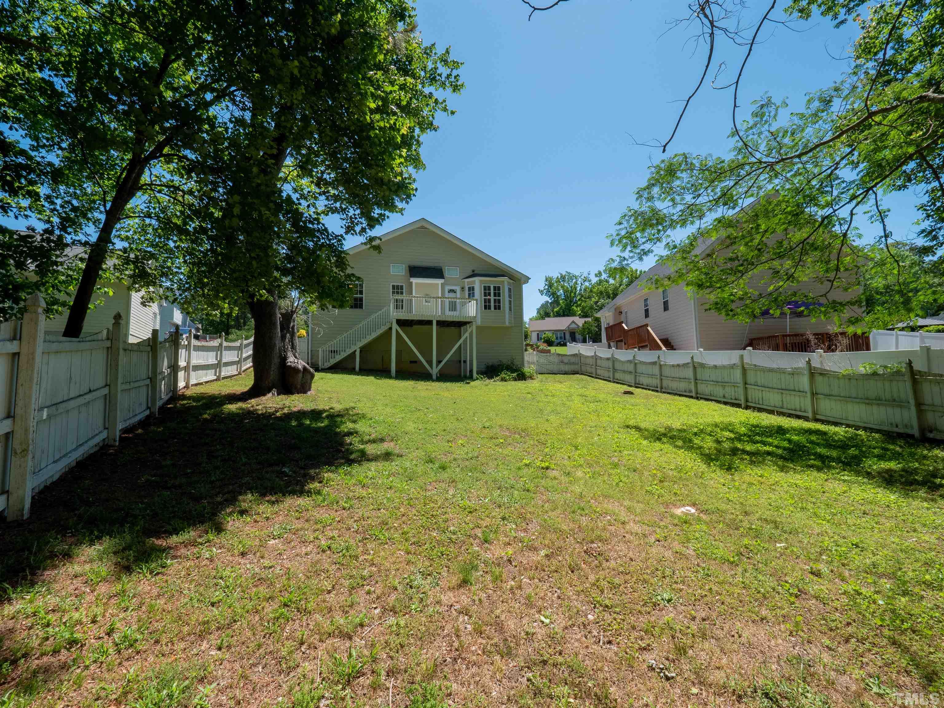 818 Shackleton Road Apex, NC 27502 - Photo 15 of 20 a view of a yard with plants and a large tree