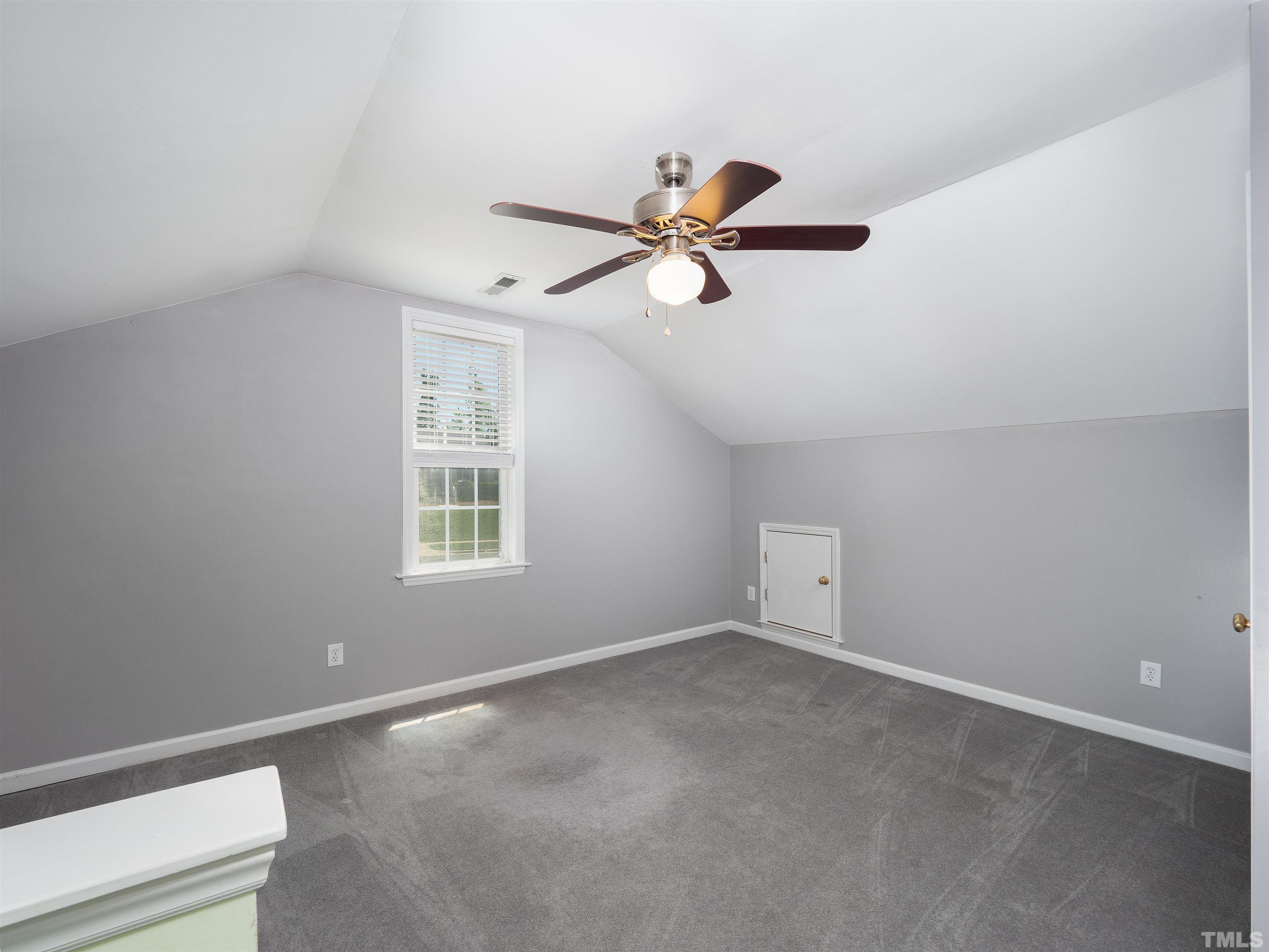 818 Shackleton Road Apex, NC 27502 - Photo 16 of 20 an empty room with a window and a fan