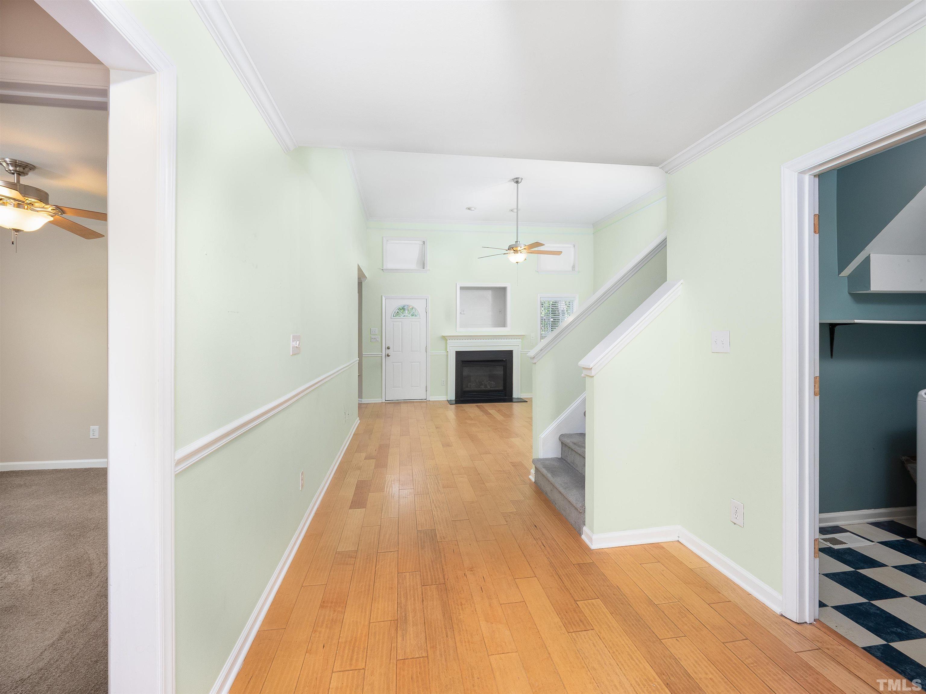 818 Shackleton Road Apex, NC 27502 - Photo 3 of 20 a view of a hallway with wooden floor and staircase