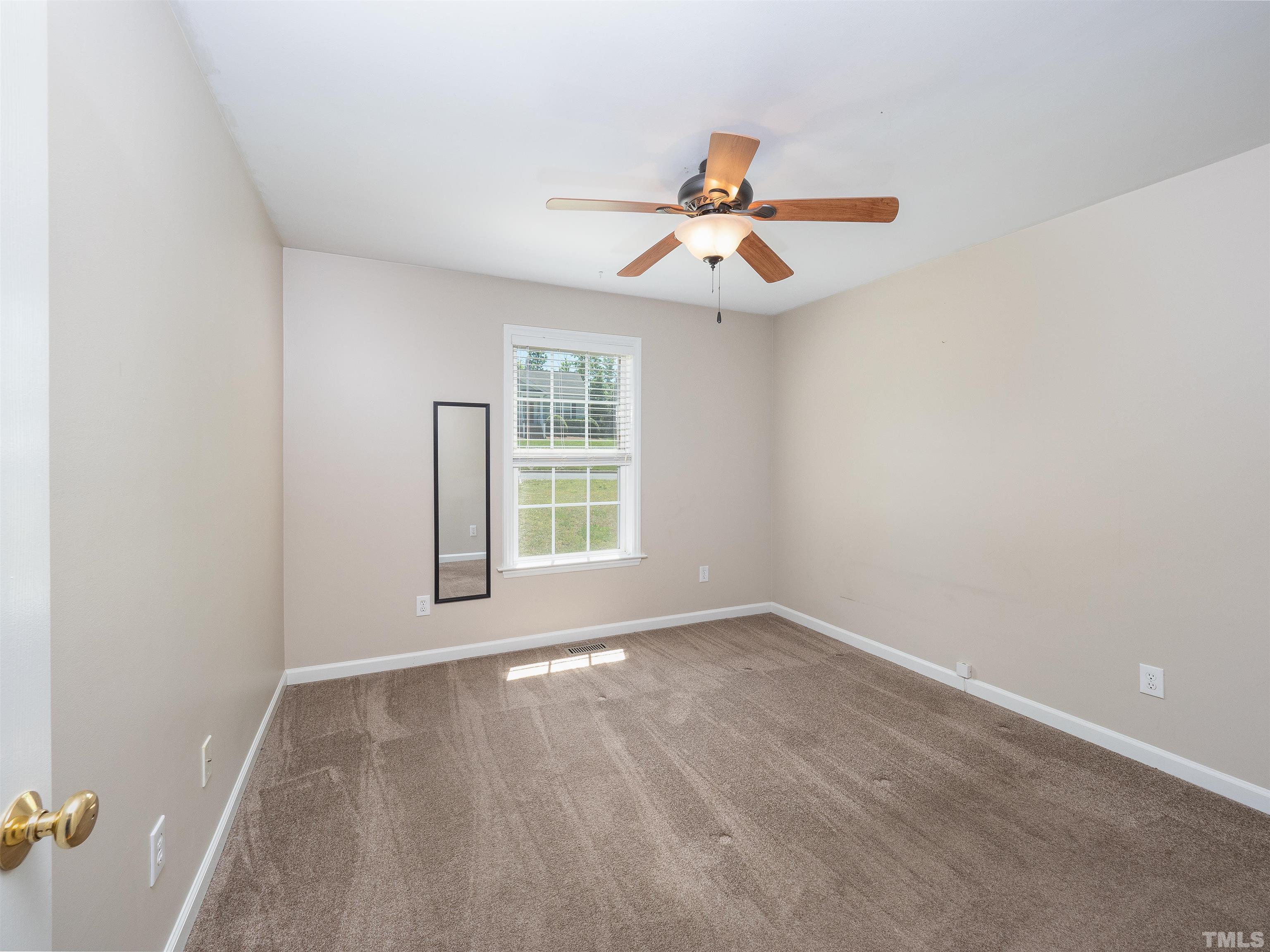 818 Shackleton Road Apex, NC 27502 - Photo 4 of 20 an empty room with windows and fan