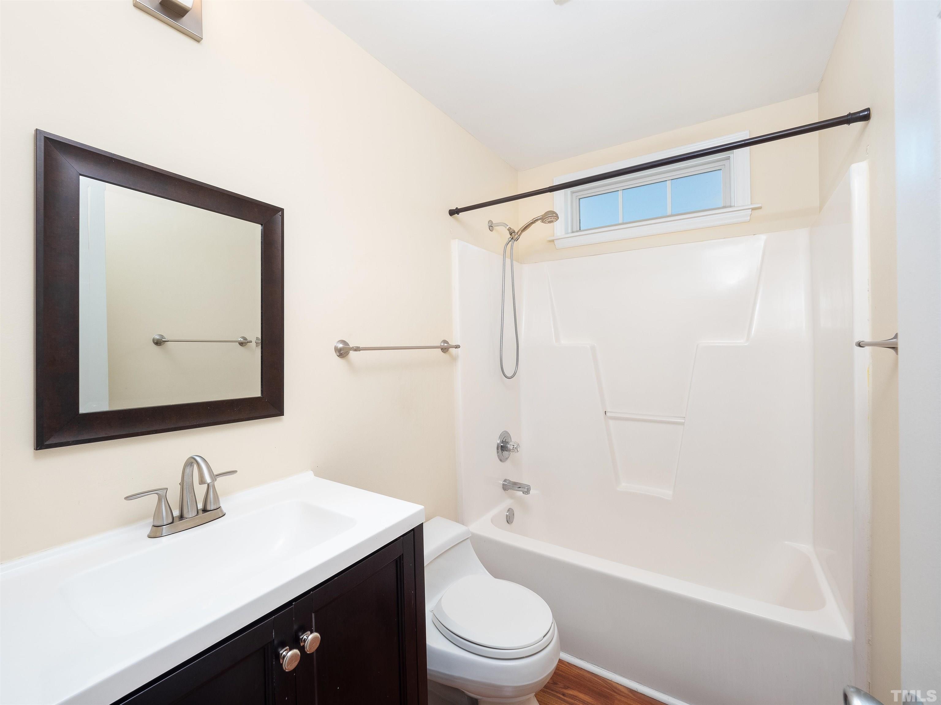 818 Shackleton Road Apex, NC 27502 - Photo 5 of 20 a bathroom with a bathtub shower sink vanity mirror and toilet