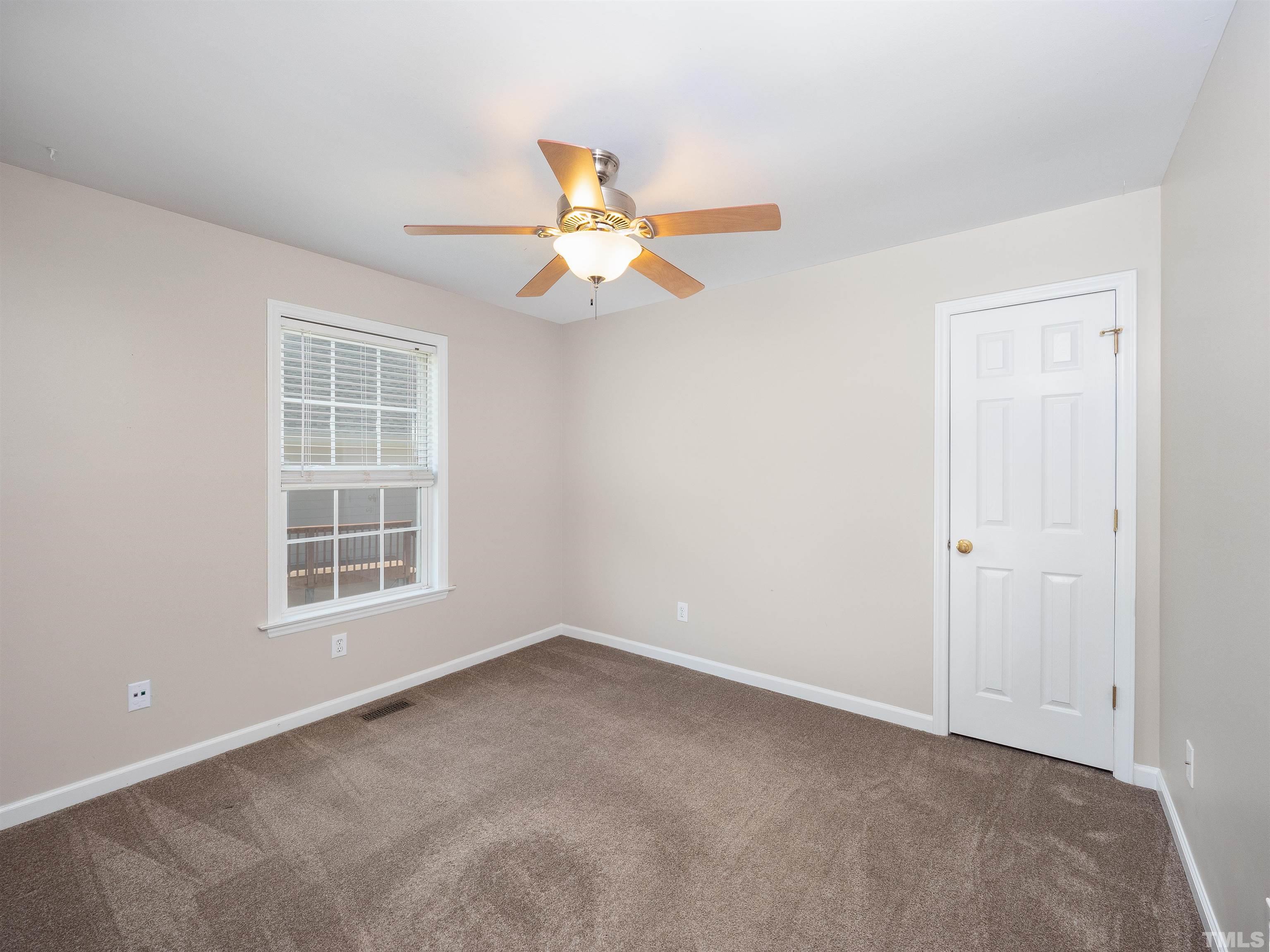 818 Shackleton Road Apex, NC 27502 - Photo 6 of 20 an empty room with windows and fan