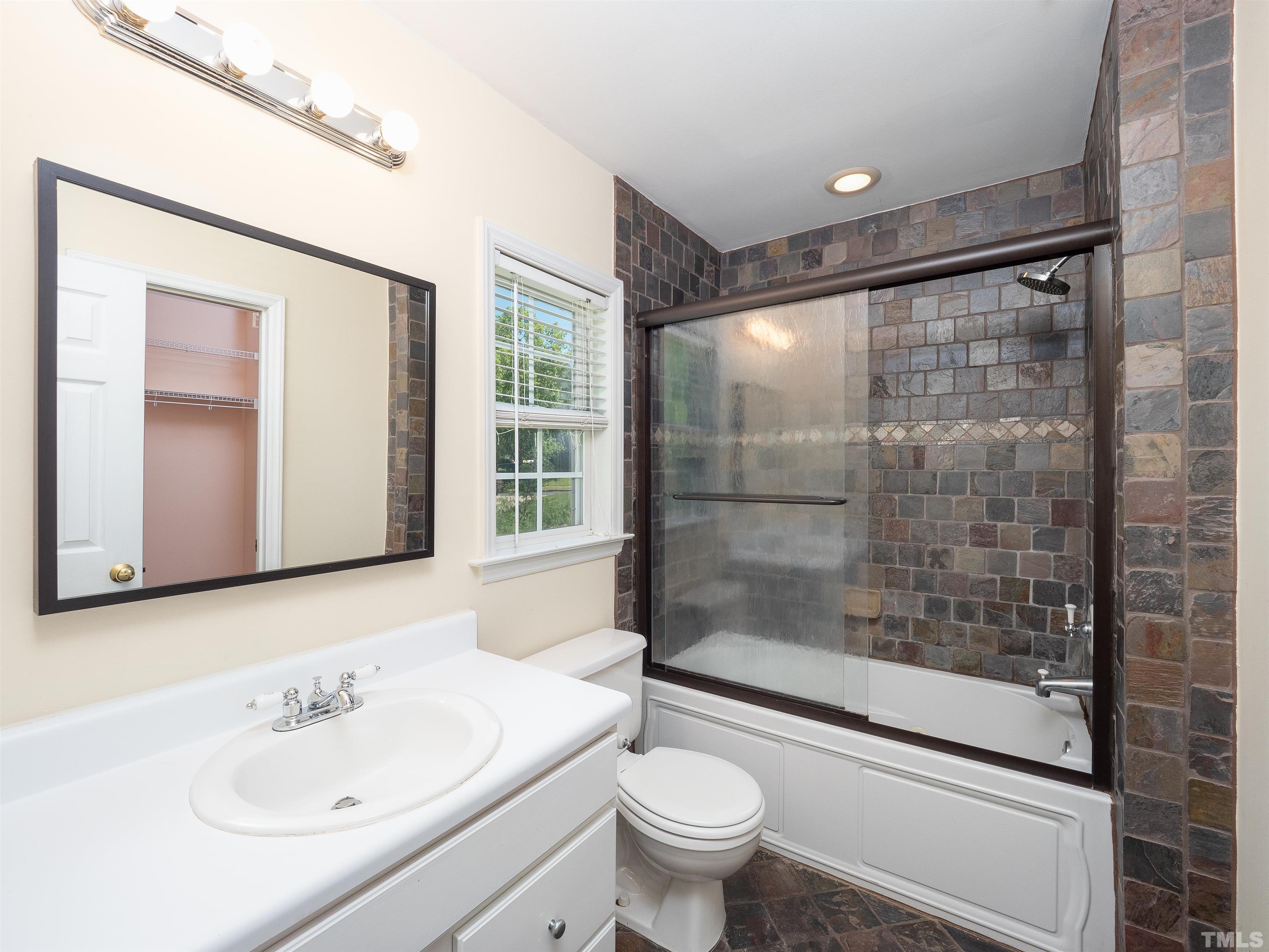 818 Shackleton Road Apex, NC 27502 - Photo 8 of 20 a bathroom with a sink mirror bathtub and toilet
