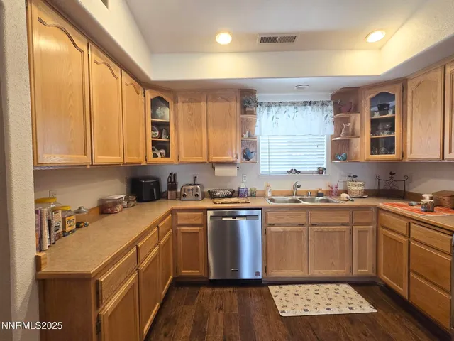 a kitchen with stainless steel appliances a stove sink microwave and cabinets