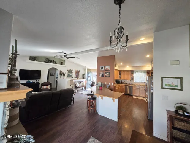 a living room with furniture a fireplace and a large window