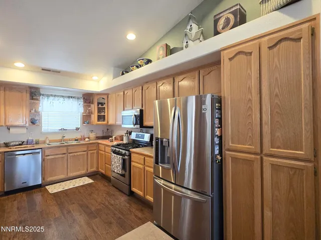 a kitchen with stainless steel appliances a sink stove and cabinets