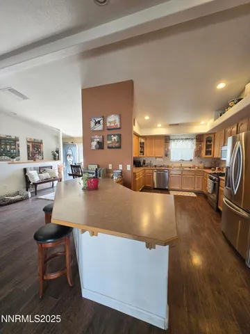 a view of a dining room with furniture a chandelier and wooden floor