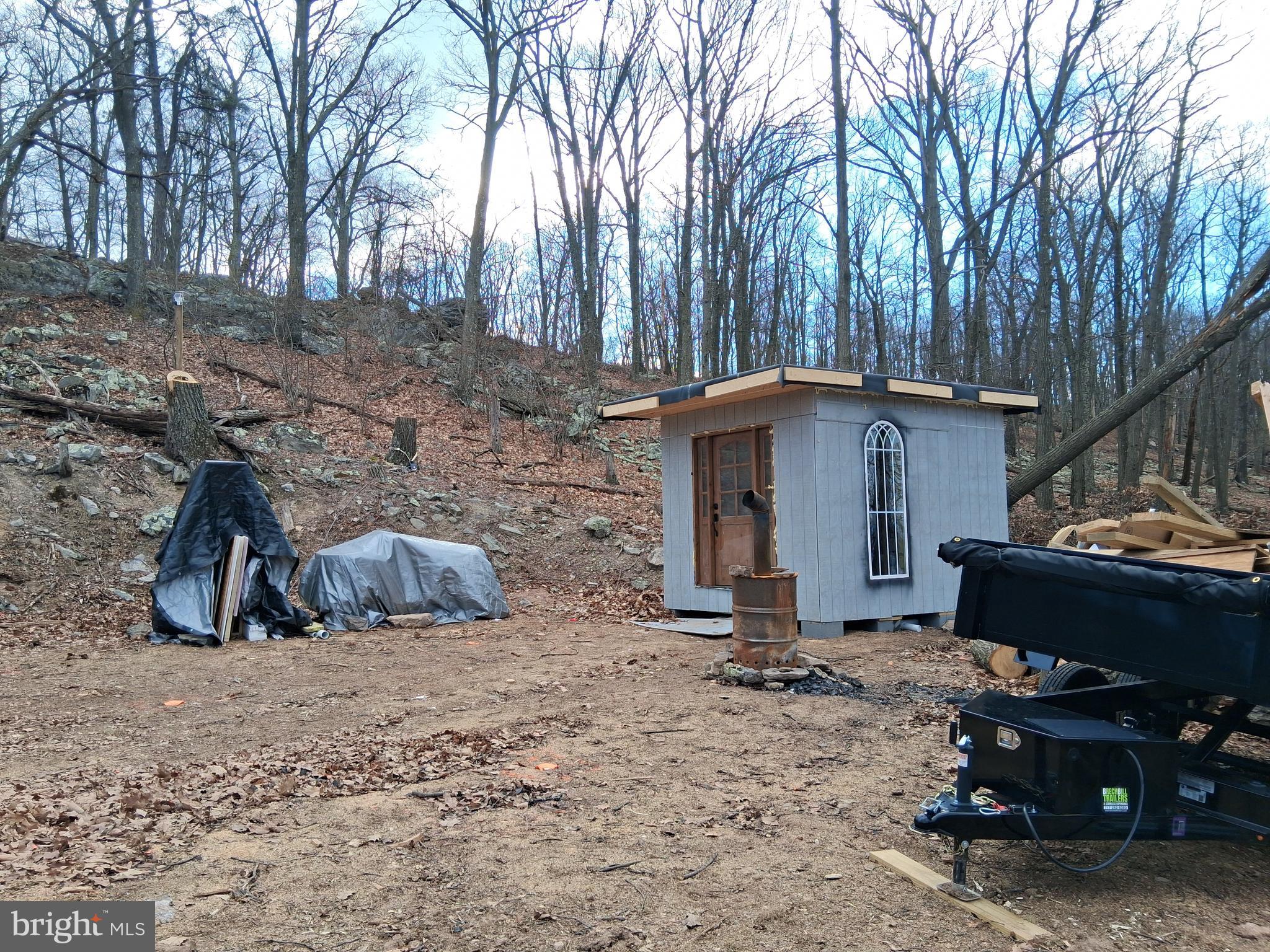 9 B Fire Tower Road Great Cacapon, WV 25422 - Photo 5 of 15 a view of a house with a yard and a tree