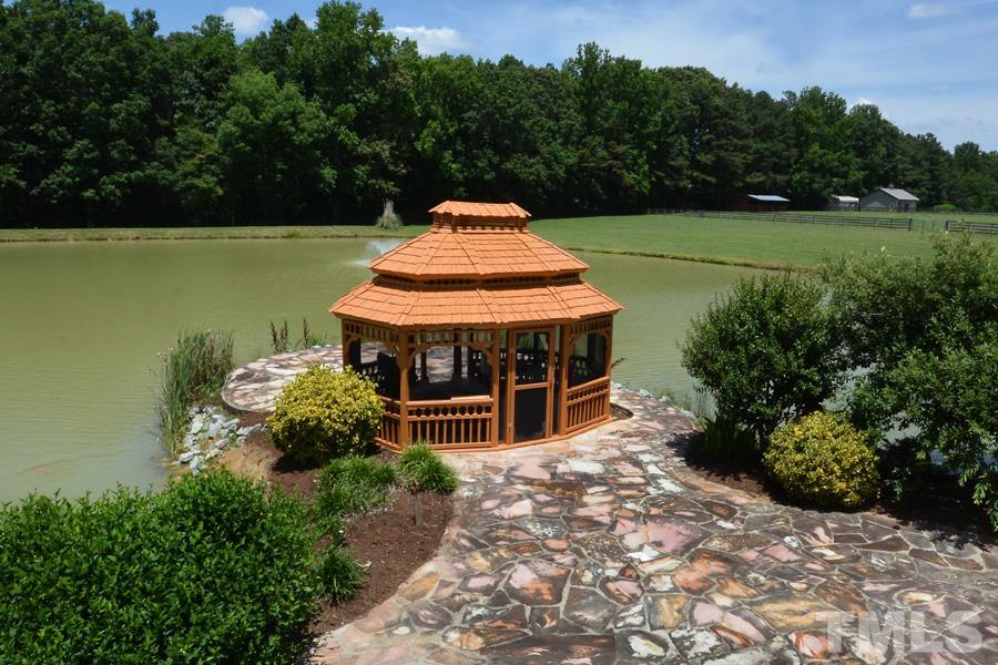 7016 Holly Ridge Road Rougemont, NC 27572 - Photo 2 of 24 A beautiful central fountain aerates the pond. The large population of colorful Japanese Koi Fish range from fingerlings to 25 pounders. On the southeast side of the pond is a boat dock with 2 canoes, 3 row boats, and a Jon boat w/ trolling motor.