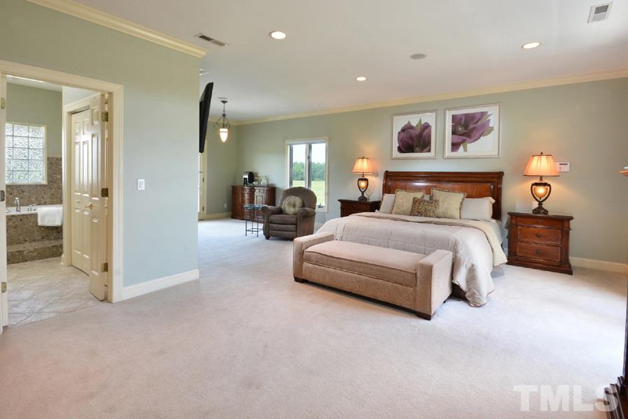 7016 Holly Ridge Road Rougemont, NC 27572 - Photo 12 of 24 A sitting room to the side faces French doors leading to the back porch. Opposite are French doors open to a front porch overlooking evergreens and the front pasture. A sizable walk-in closet / dressing room is lined with convenient built-ins.