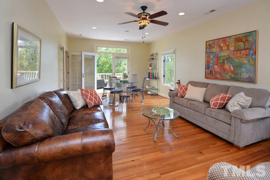 7016 Holly Ridge Road Rougemont, NC 27572 - Photo 17 of 24 The front to back living room has French doors opening to a view of the front rose gardens on one side, and open to the rear porch on the other side.
