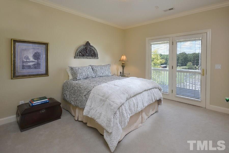 7016 Holly Ridge Road Rougemont, NC 27572 - Photo 19 of 24 French doors open to the back porch. A deep double door closet has storage built-ins.