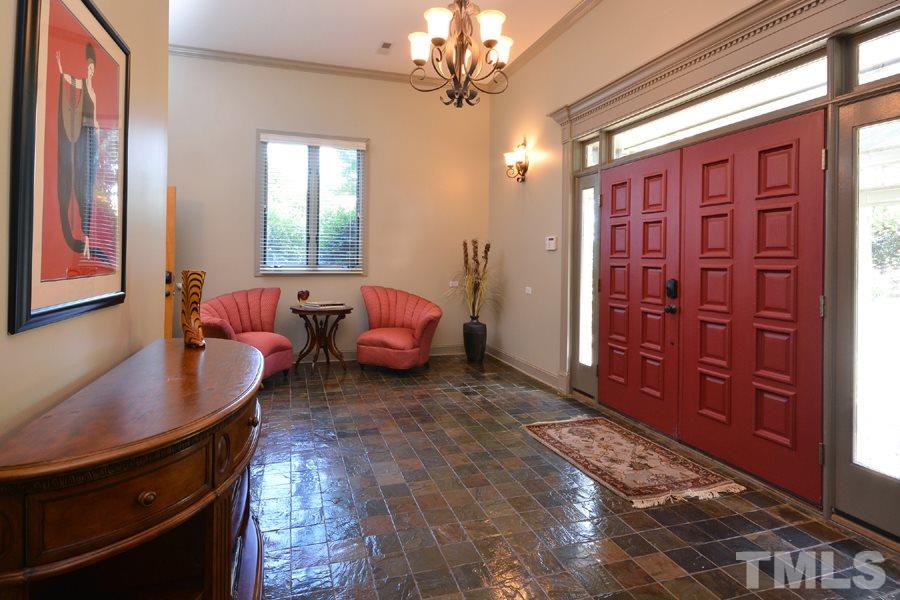 7016 Holly Ridge Road Rougemont, NC 27572 - Photo 22 of 24 Elegant Therma-Tru front doors enter onto gleaming stone tiled floors. A wood paneled elevator whisks you up to the main living level.