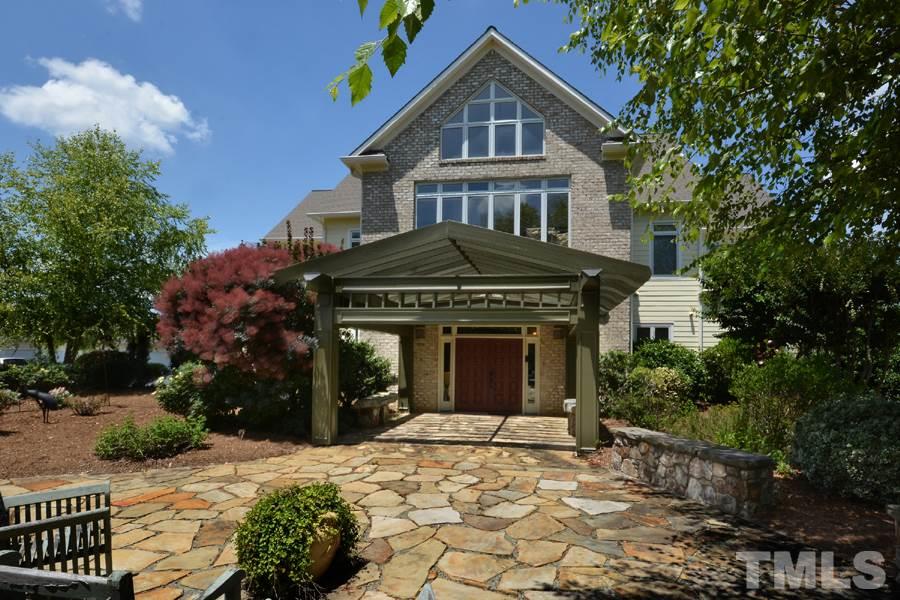 7016 Holly Ridge Road Rougemont, NC 27572 - Photo 24 of 24 The front patio offers a wide expanse of stone paving bordered by a low stone wall; the perfect spot to rest on the classic stone benches and quietly contemplate the gardens and flowering trees.