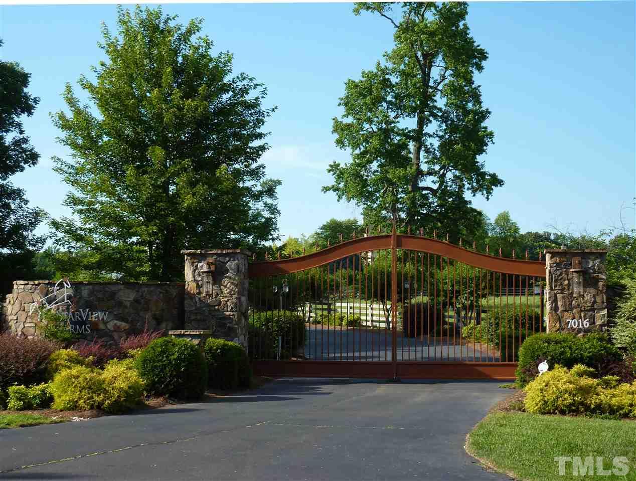7016 Holly Ridge Road Rougemont, NC 27572 - Photo 6 of 24 Mounted on an impressive edifice of stone, these steel front gates are controlled by a call box and intercom.