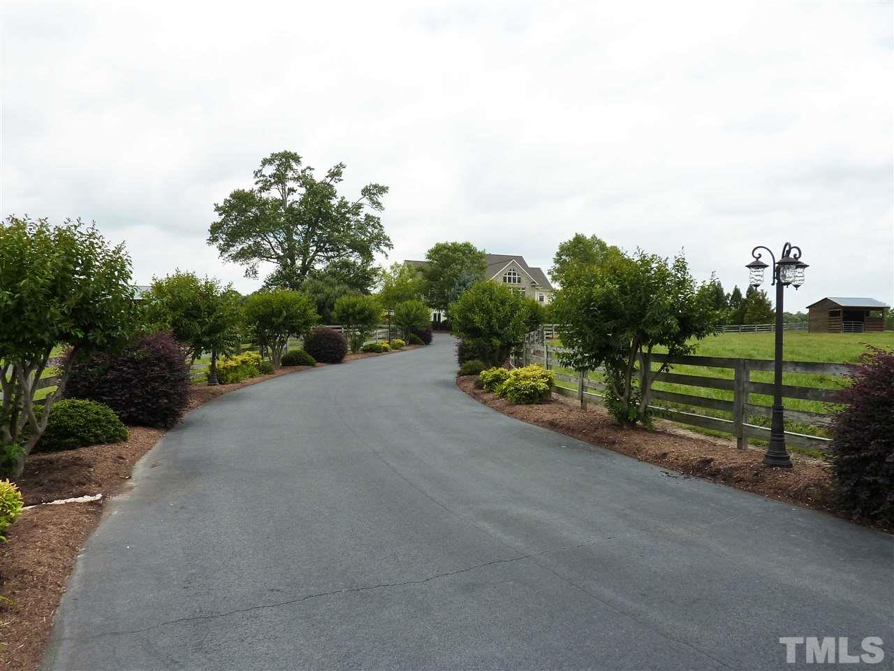 7016 Holly Ridge Road Rougemont, NC 27572 - Photo 7 of 24 Upon entering the gates, you follow a long curving drive lined by exquisitely maintained landscaping and antique style street lamps.